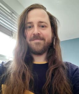 My selfie. A handsome chap with long wavy hair, a tidy beard and a big smile